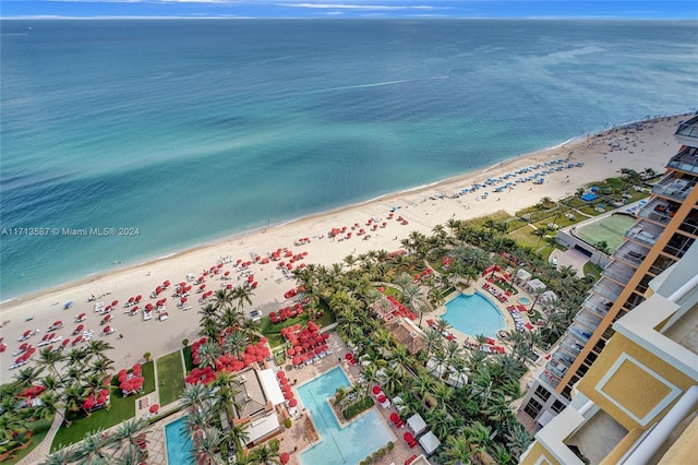 birds eye view of property with a water view and a view of the beach