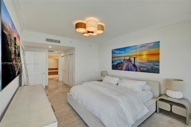 bedroom with a closet and crown molding