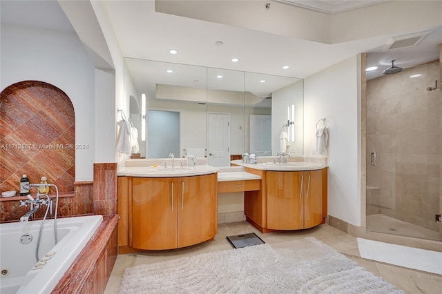 bathroom featuring vanity, tile patterned flooring, and plus walk in shower