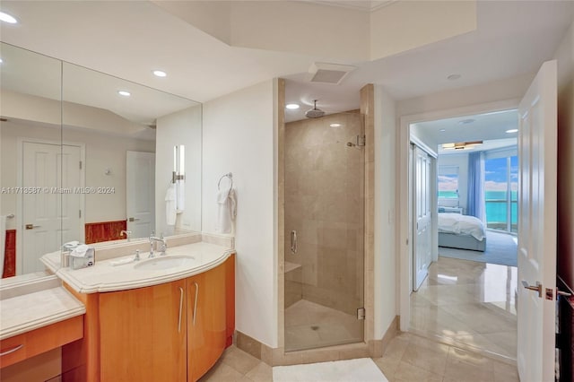 bathroom with vanity, walk in shower, and tile patterned flooring