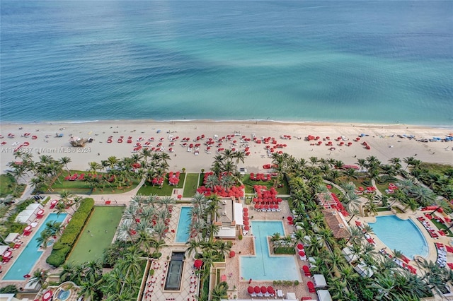 aerial view with a water view and a beach view