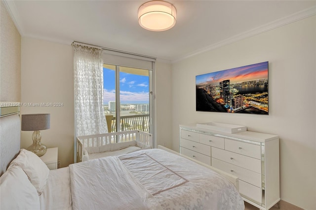 bedroom with crown molding and access to outside