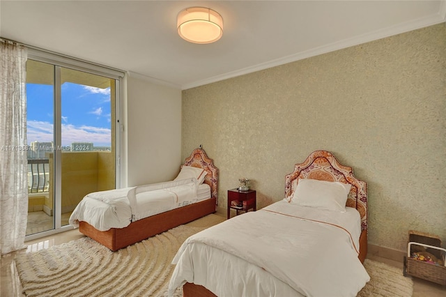 bedroom with access to exterior, a wall of windows, and ornamental molding