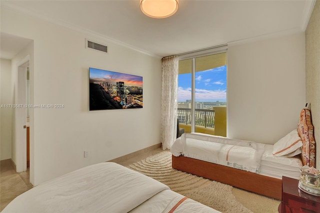 bedroom with access to exterior and crown molding