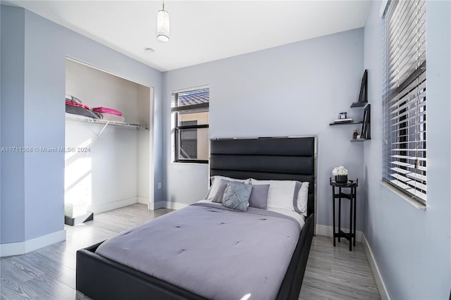 bedroom featuring light hardwood / wood-style floors and a closet