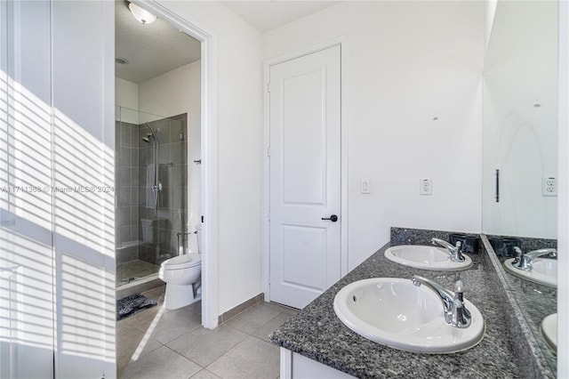 bathroom with tile patterned floors, walk in shower, a textured ceiling, vanity, and toilet