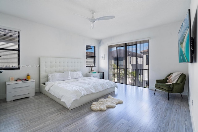 bedroom featuring ceiling fan, light hardwood / wood-style floors, and access to outside