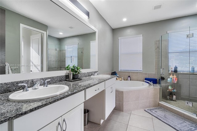 bathroom with tile patterned flooring, vanity, and independent shower and bath