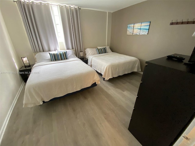 bedroom with light wood-style floors