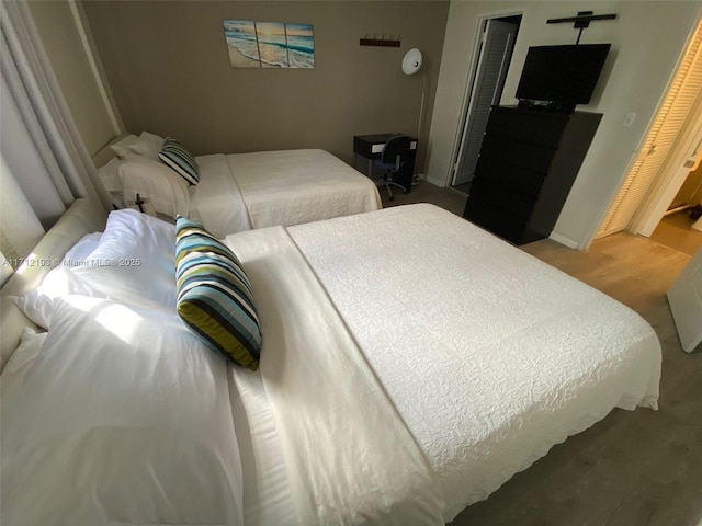 bedroom featuring wood finished floors and baseboards