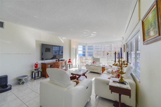 living room with floor to ceiling windows, light tile patterned flooring, and a textured ceiling