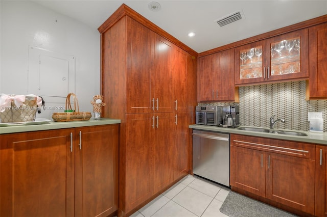 kitchen featuring light tile patterned floors, tasteful backsplash, stainless steel dishwasher, and sink