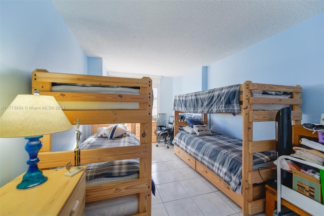 bedroom with light tile patterned floors and a textured ceiling