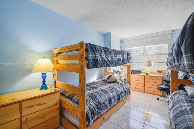 tiled bedroom featuring a textured ceiling