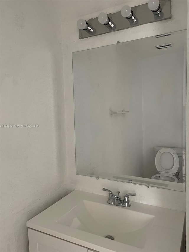 bathroom featuring vanity and toilet