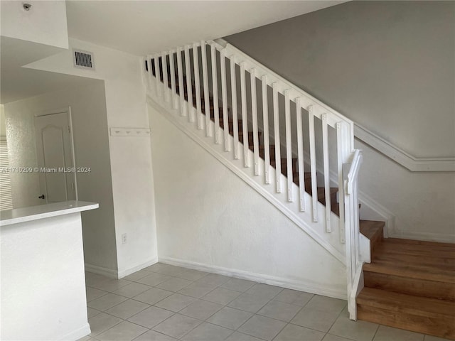 staircase featuring tile patterned floors