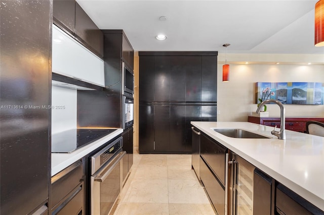 kitchen with sink, pendant lighting, black appliances, and backsplash