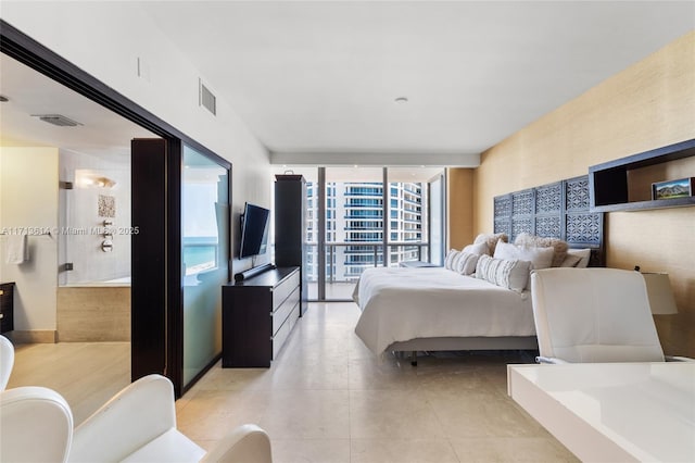 bedroom featuring floor to ceiling windows and light tile patterned floors