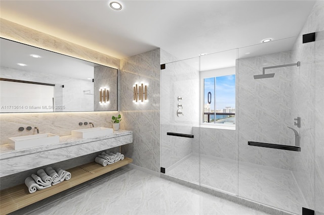 bathroom with tile walls, vanity, and a shower with door