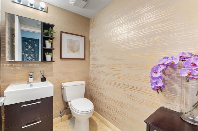 bathroom with vanity, tile patterned floors, and toilet