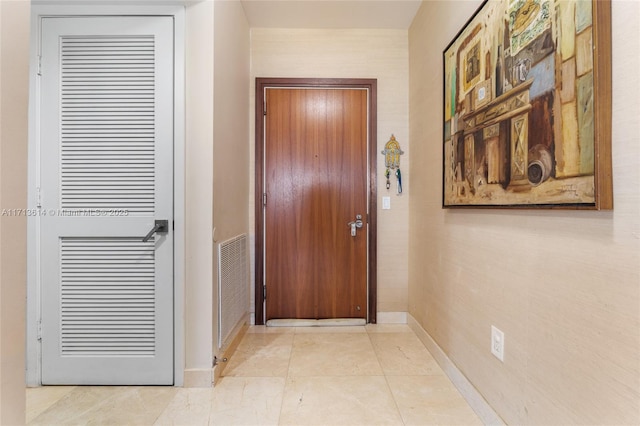 doorway featuring light tile patterned flooring