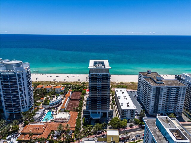 birds eye view of property featuring a water view and a view of the beach