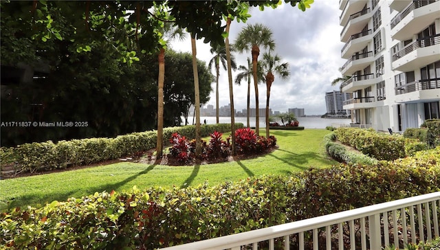 surrounding community featuring a water view and a yard