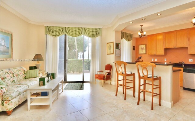 kitchen featuring light tile patterned flooring, an inviting chandelier, stainless steel refrigerator, ornamental molding, and pendant lighting