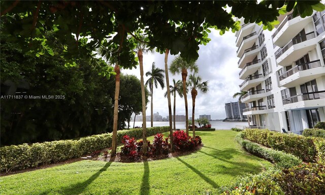 view of community featuring a yard and a water view