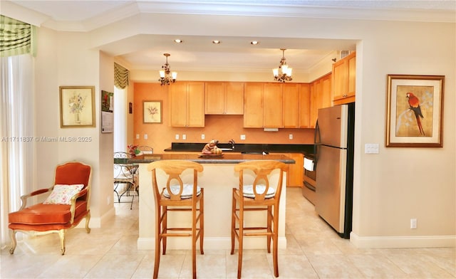 kitchen with decorative light fixtures, stainless steel fridge, a chandelier, and a kitchen island