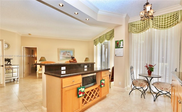 kitchen with light tile patterned floors, crown molding, and a textured ceiling