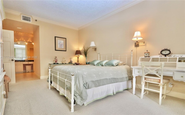 bedroom with ornamental molding, light colored carpet, a textured ceiling, and ensuite bathroom