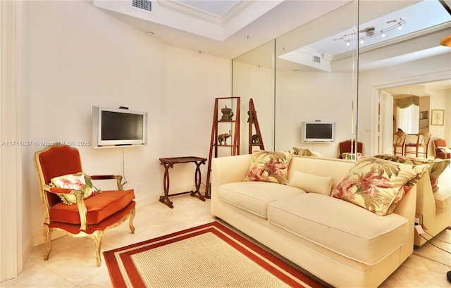 tiled living room featuring a raised ceiling and ornamental molding