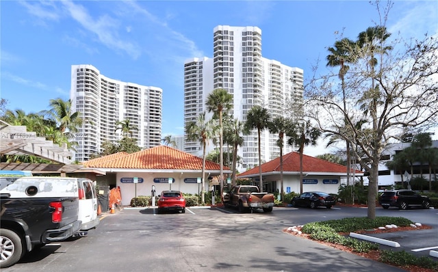 view of building exterior with a city view and uncovered parking