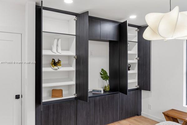 mudroom featuring baseboards, recessed lighting, and light wood-style flooring