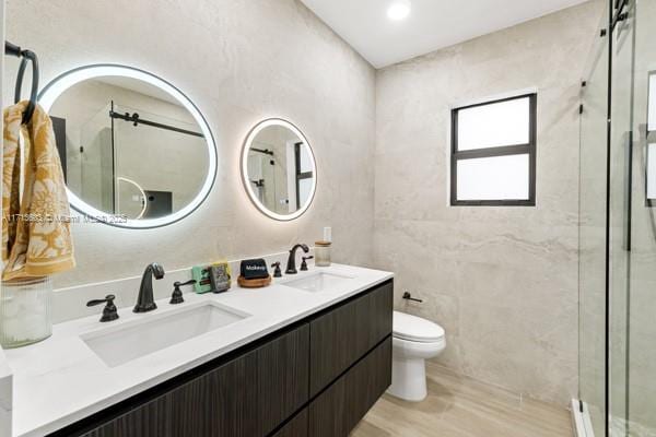 bathroom featuring vanity, toilet, and walk in shower