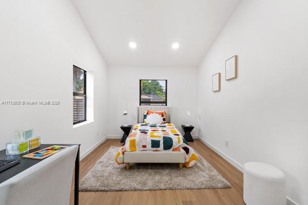 bedroom featuring recessed lighting, baseboards, and light wood-type flooring