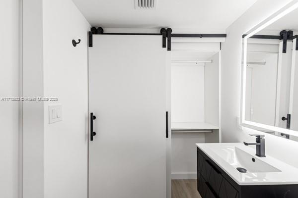 bathroom with vanity and wood-type flooring