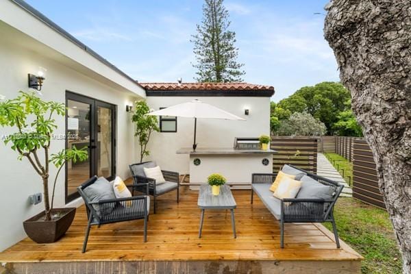 wooden terrace featuring outdoor lounge area