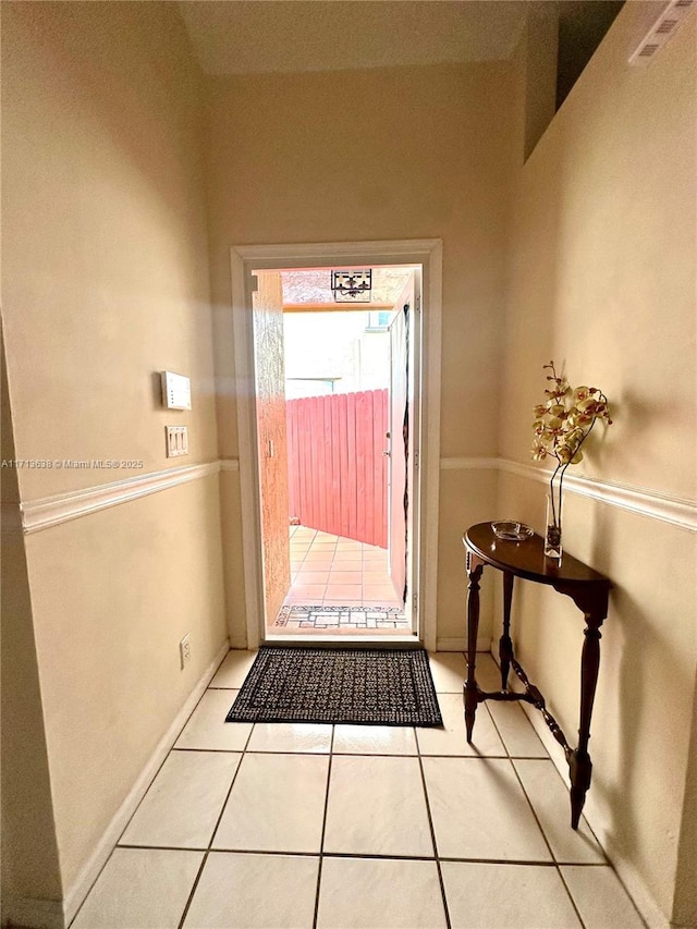 doorway with light tile patterned floors