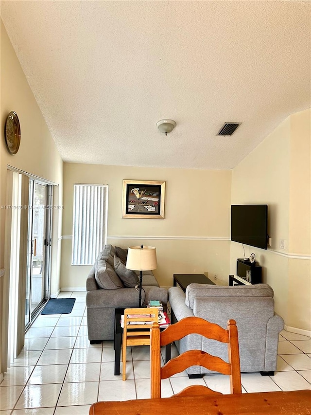 tiled living room with a textured ceiling