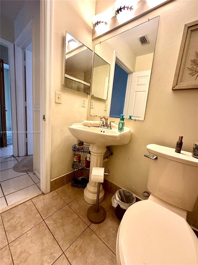 bathroom with tile patterned flooring and toilet