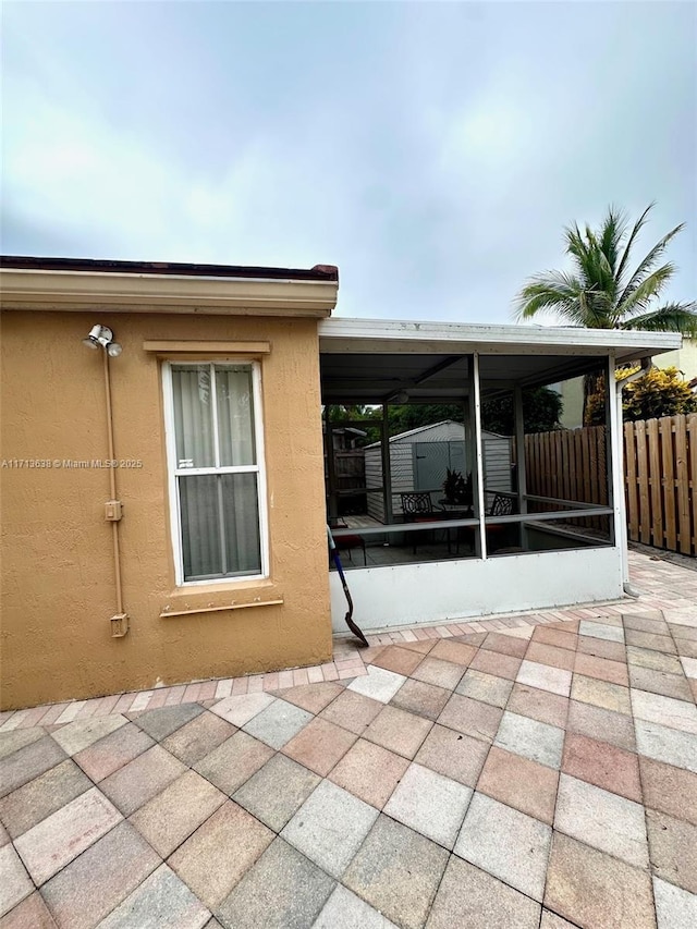 view of patio / terrace featuring a sunroom