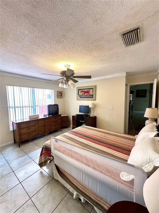 tiled bedroom featuring ceiling fan, crown molding, and a textured ceiling