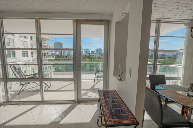 doorway with a wall of windows, a textured ceiling, and light tile patterned floors