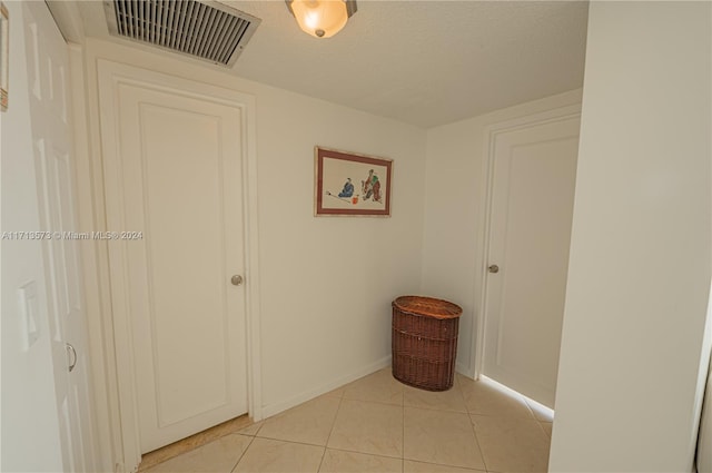 hallway with light tile patterned floors