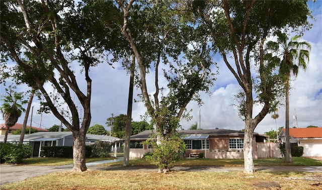 single story home with fence and a front lawn