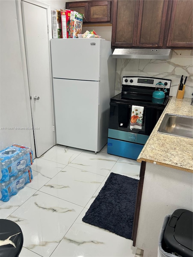 kitchen with stainless steel range with electric cooktop, sink, tasteful backsplash, dark brown cabinets, and white fridge