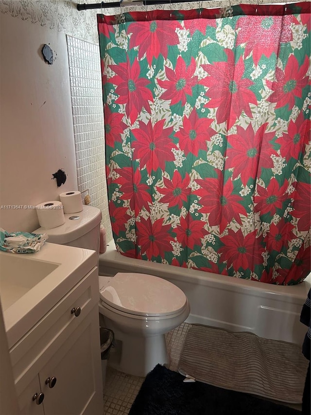 bathroom with tile patterned flooring, vanity, and toilet