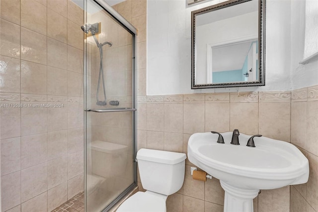 bathroom featuring an enclosed shower, tile walls, and toilet